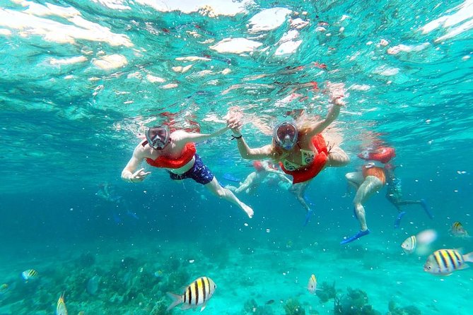 Catamaran Cruise Full Day Tour to Reef, Caves and Negril Beach - Boarding the catamaran: reggae, open bar, and deck time