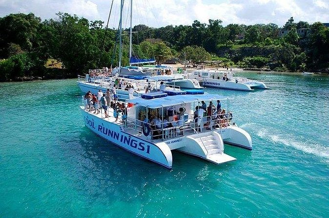 Dunn's River Falls Party Cruise, Blue Hole with Snorkeling, free beverages - The party catamaran: open bar, DJ energy, and social cruising